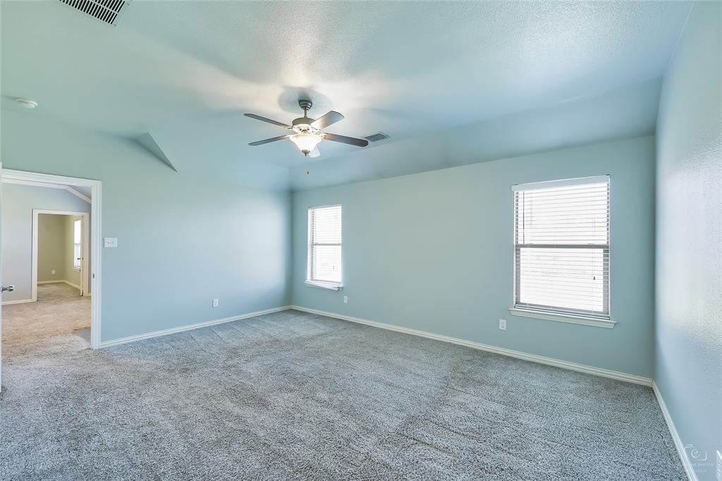 6601 Pine Hills Lane Denton, TX 76210 - Photo 12 of 23 Carpeted empty room with a ceiling fan and a textured ceiling