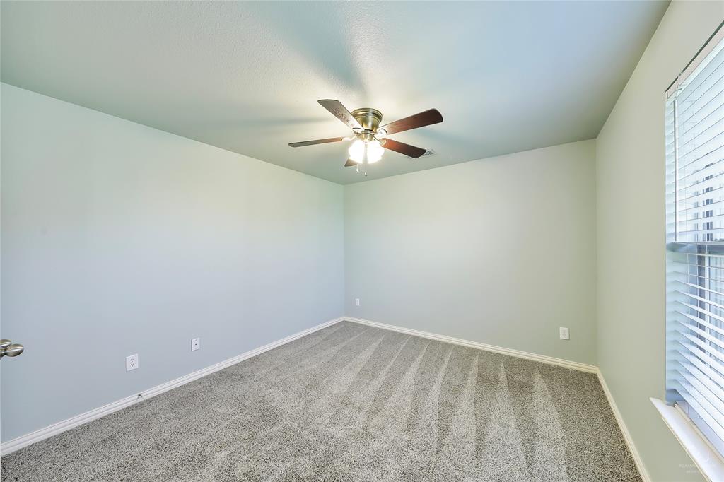 6601 Pine Hills Lane Denton, TX 76210 - Photo 15 of 23 Carpeted spare room with baseboards and ceiling fan
