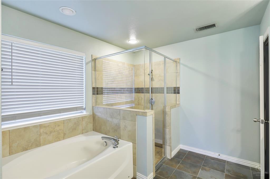 6601 Pine Hills Lane Denton, TX 76210 - Photo 19 of 23 Bathroom featuring a stall shower and a garden tub