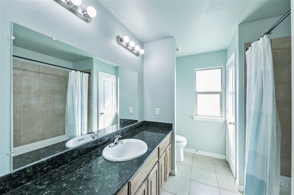 6601 Pine Hills Lane Denton, TX 76210 - Photo 20 of 23 Full bath with light tile patterned floors, vanity, a shower with curtain, and a textured ceiling