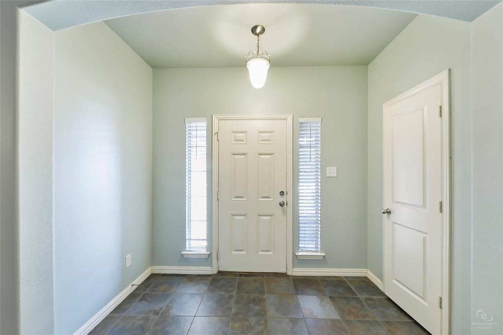 6601 Pine Hills Lane Denton, TX 76210 - Photo 3 of 23 Foyer entrance featuring baseboards and arched walkways