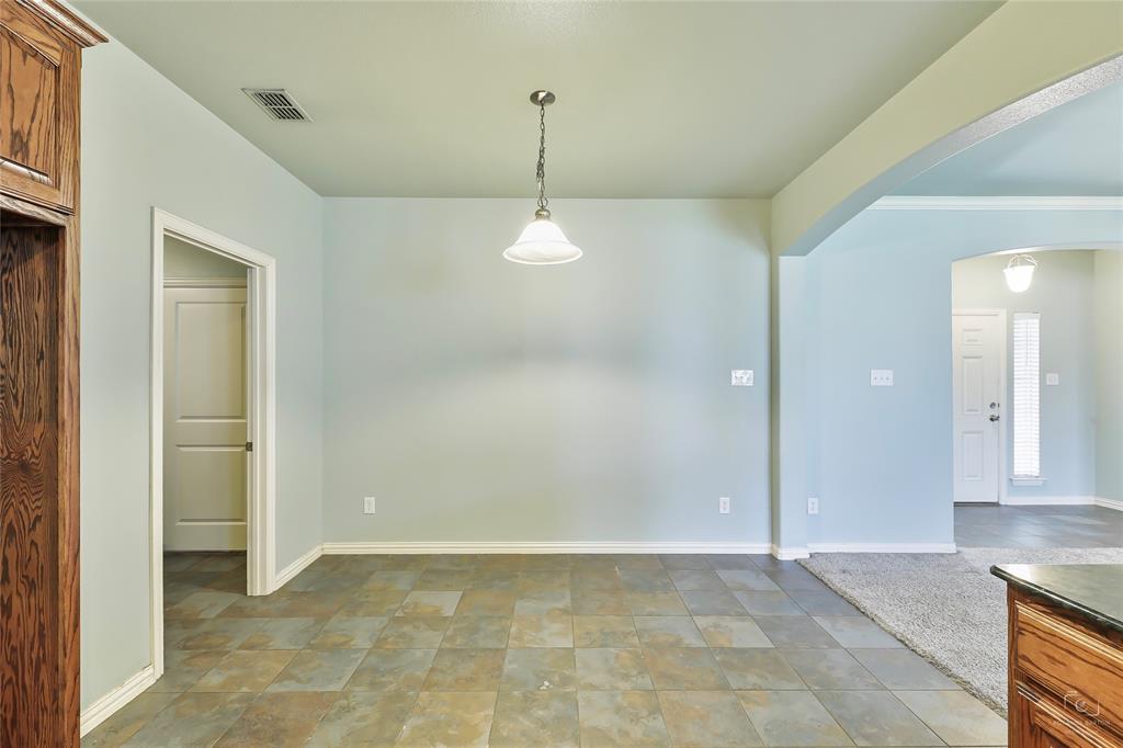 6601 Pine Hills Lane Denton, TX 76210 - Photo 6 of 23 Unfurnished dining area featuring baseboards and arched walkways