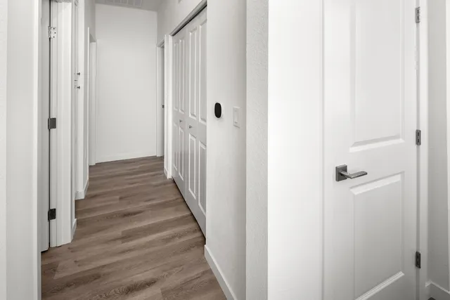 a view of a hallway with wooden floor