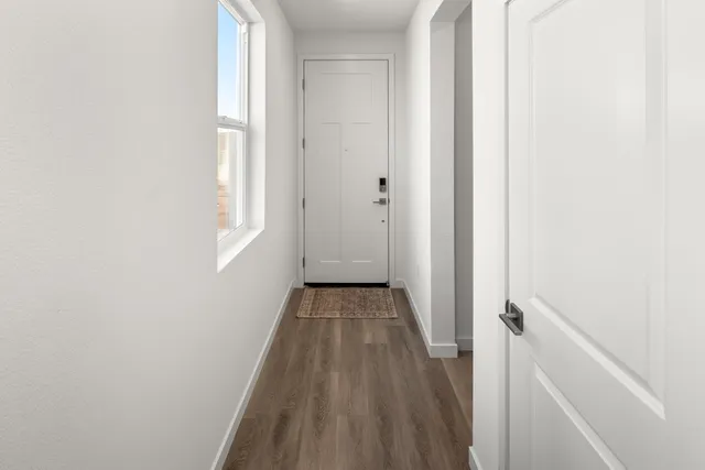 a view of a room with wooden floor and a window