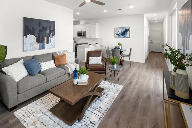 a living room with furniture and wooden floor