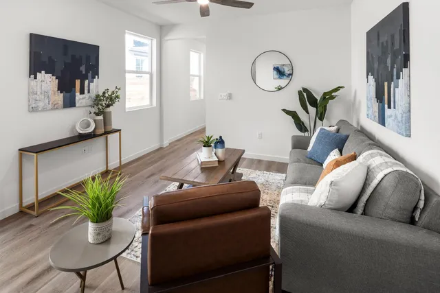 a living room with furniture and a potted plant