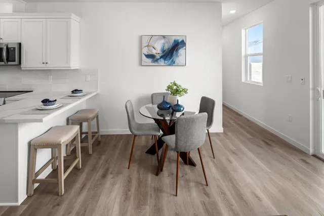 a view of a dining room with furniture and wooden floor