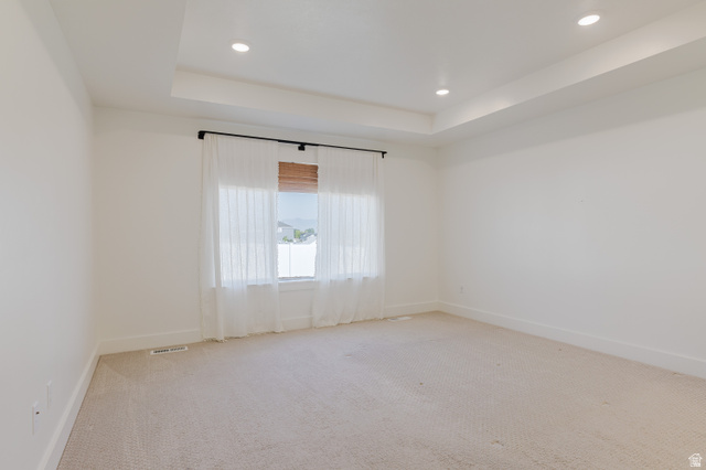 433 North 600 West Smithfield, UT 84335 - Photo 29 of 40 Recessed lighting illuminates the tray ceiling in this neutral room, featuring a large window, carpeted flooring, and base molding