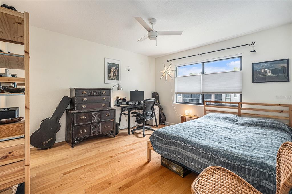 2368 Flanders Way, Unit D Safety Harbor, FL 34695 - Photo 11 of 25 a bedroom with a bed and wooden floor
