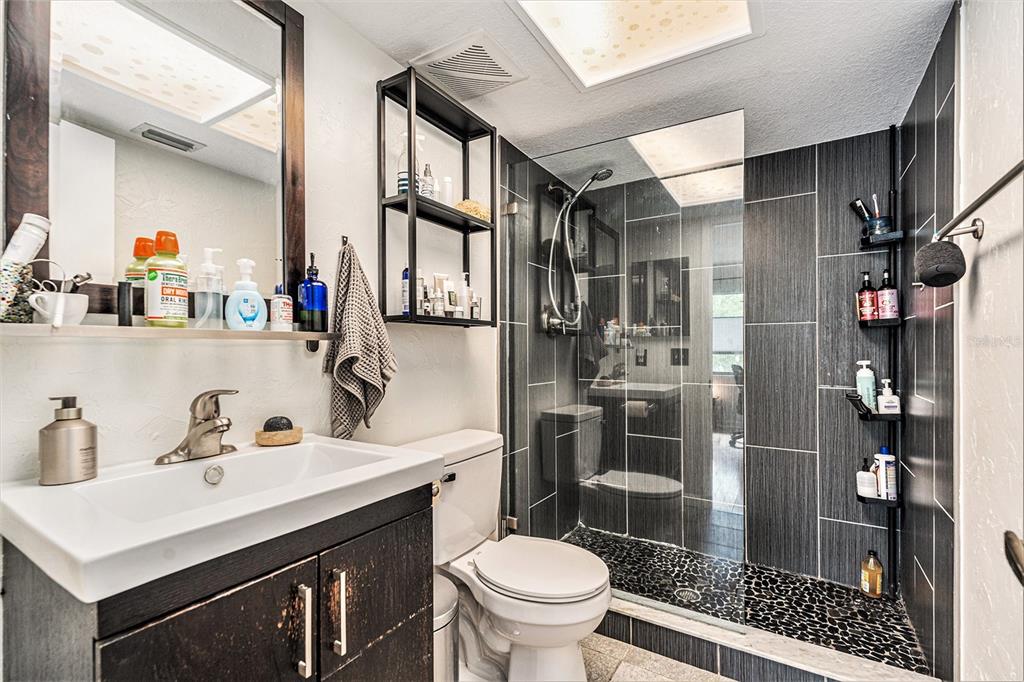 2368 Flanders Way, Unit D Safety Harbor, FL 34695 - Photo 13 of 25 a bathroom with a sink toilet and shower