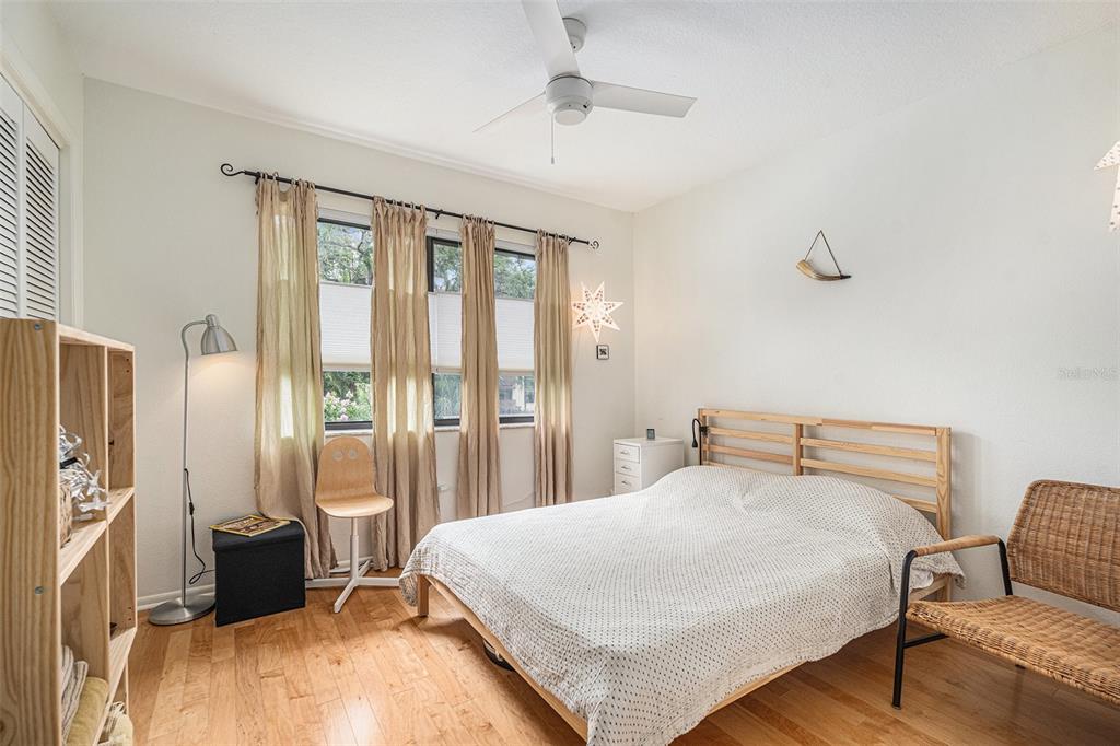 2368 Flanders Way, Unit D Safety Harbor, FL 34695 - Photo 17 of 25 a bedroom with a bed and wooden floor