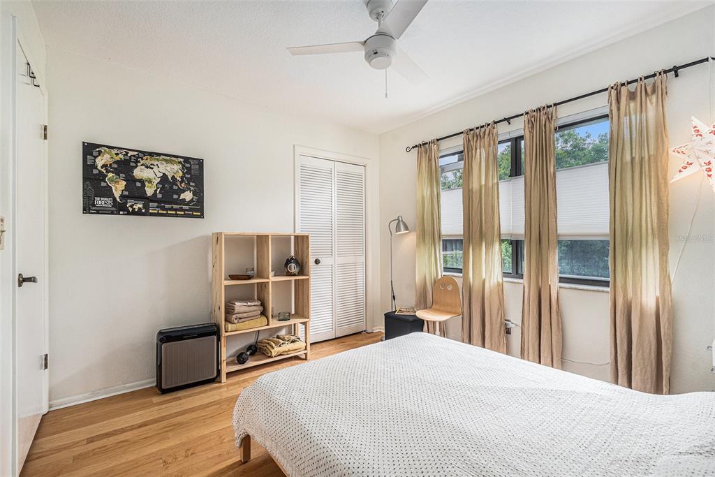 2368 Flanders Way, Unit D Safety Harbor, FL 34695 - Photo 18 of 25 a bedroom with a bed and a painting on the wall