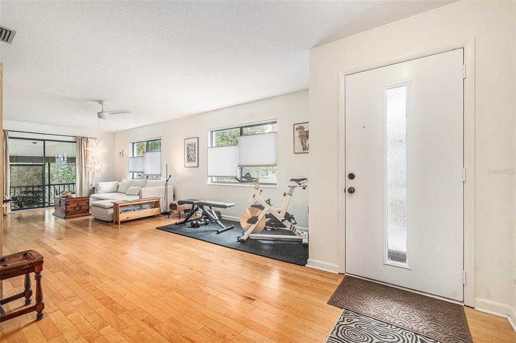 2368 Flanders Way, Unit D Safety Harbor, FL 34695 - Photo 4 of 25 a living room with furniture and a wooden floor