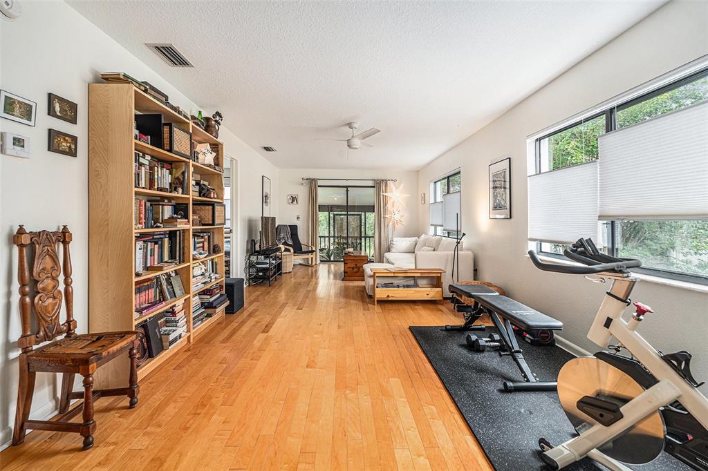 2368 Flanders Way, Unit D Safety Harbor, FL 34695 - Photo 5 of 25 a living room with furniture and a book shelf