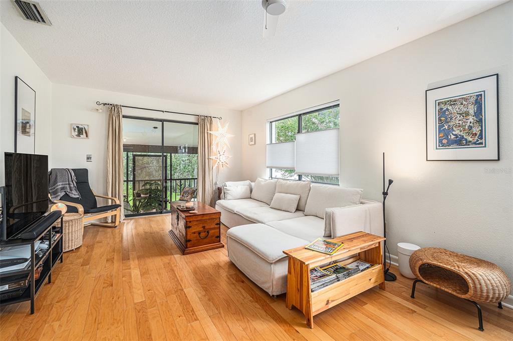2368 Flanders Way, Unit D Safety Harbor, FL 34695 - Photo 6 of 25 a living room with furniture and a flat screen tv