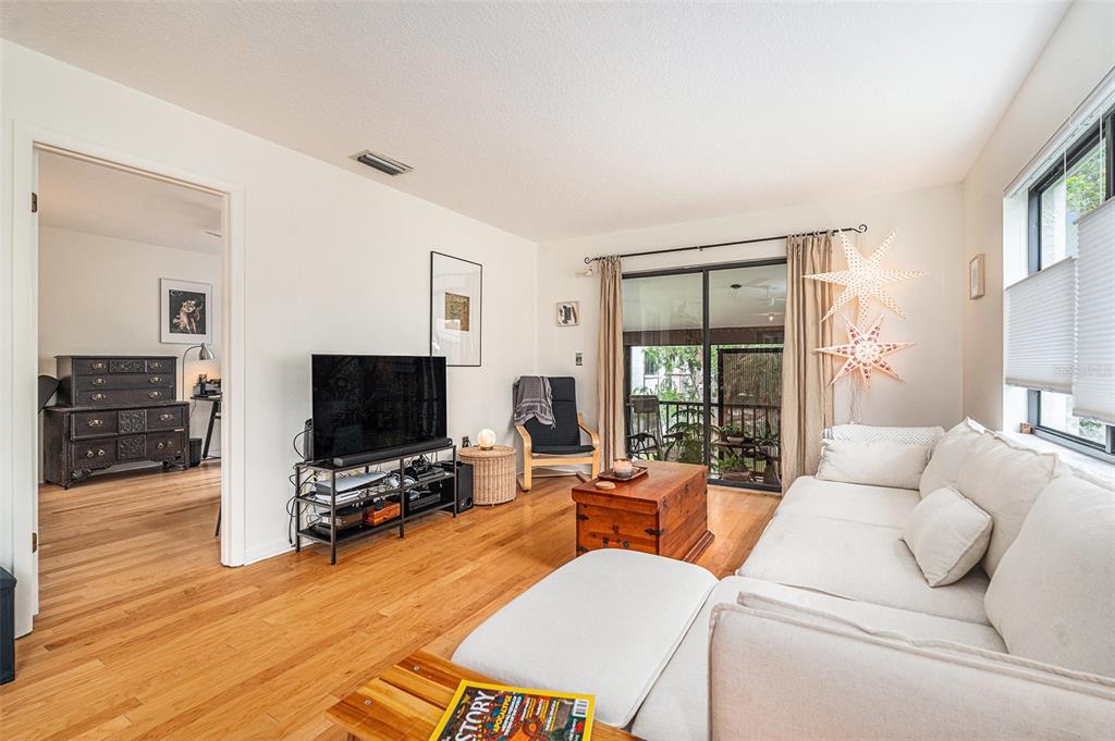 2368 Flanders Way, Unit D Safety Harbor, FL 34695 - Photo 8 of 25 a living room with furniture and a flat screen tv
