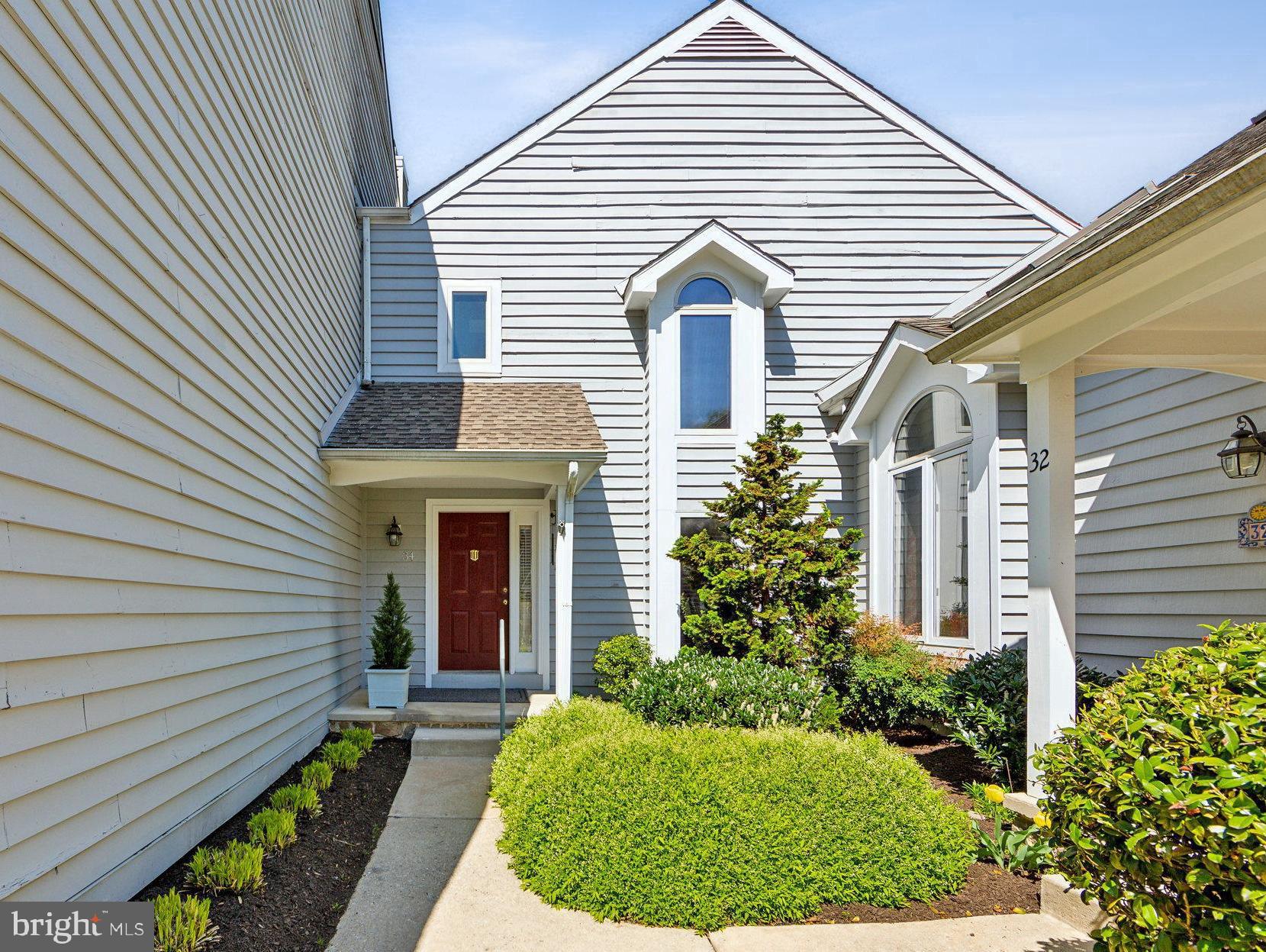 34 Mallard Mill Run Wallingford, PA 19086 - Photo 2 of 31 a view of a white house with potted plants next to a yard