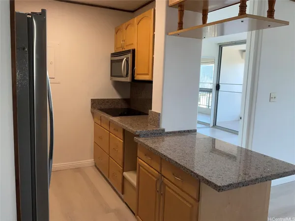 a kitchen with stainless steel appliances granite countertop a sink and a refrigerator