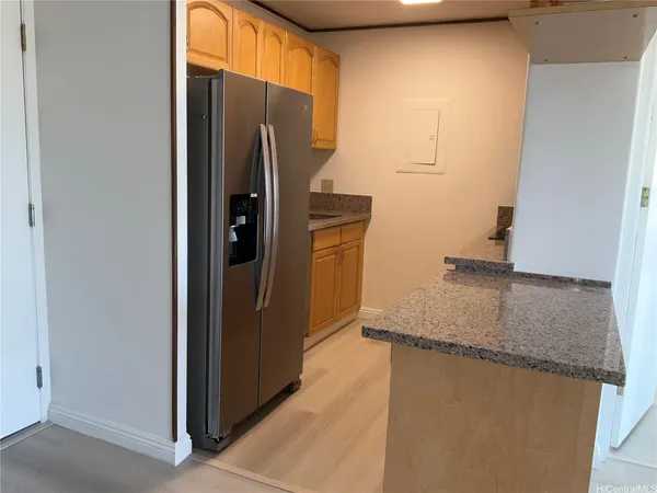 a kitchen with stainless steel appliances granite countertop a refrigerator and a sink
