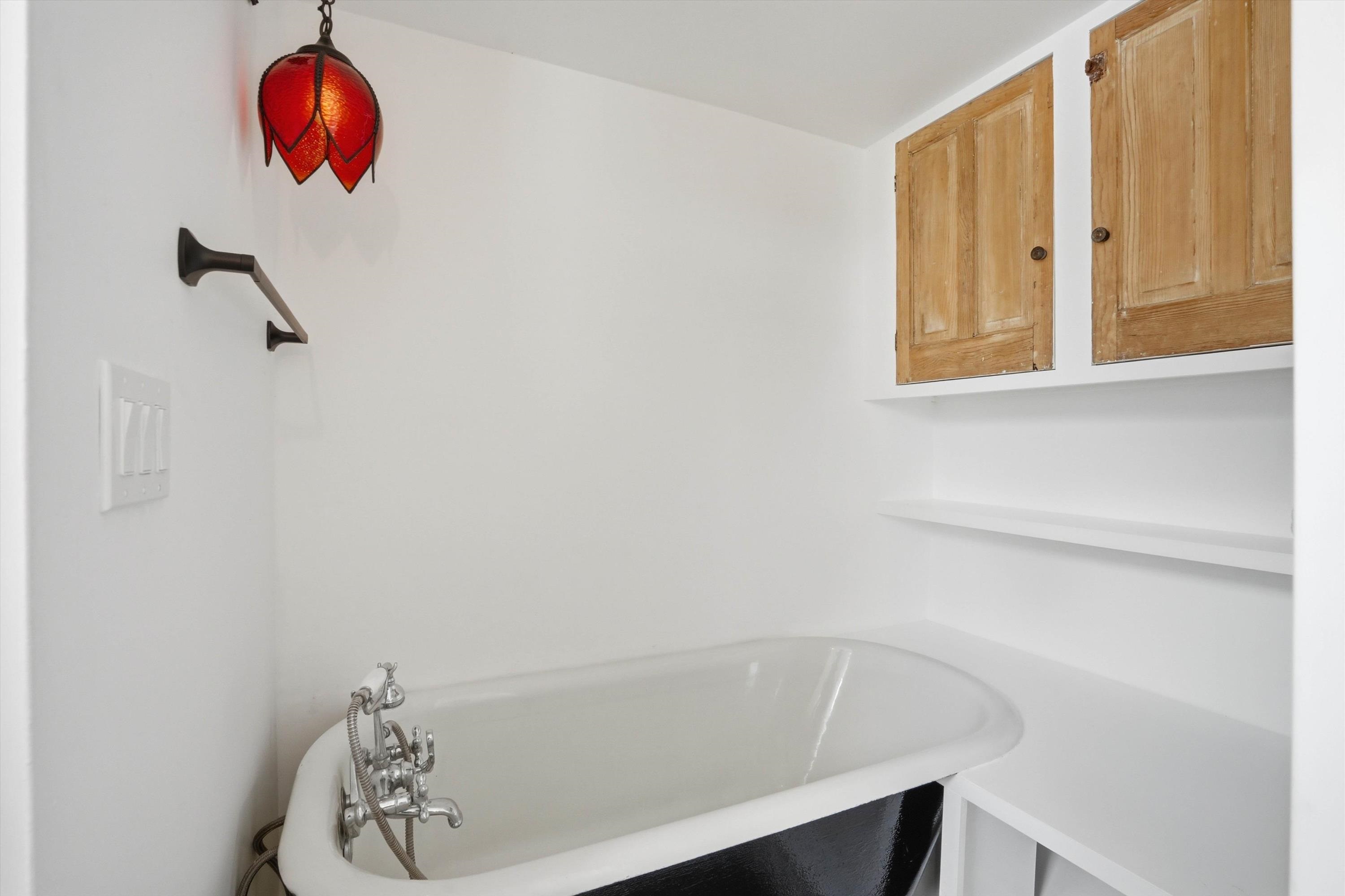 76 Oneida Street St. Augustine, FL 32084 - Photo 25 of 38 a bathroom with a bathtub and shower