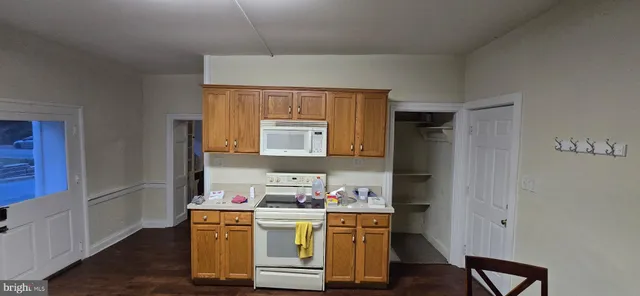 a room with a sink cabinets and wooden floor
