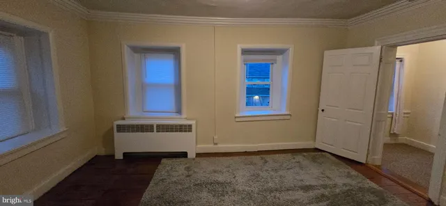 a view of a closet area fire place and a window