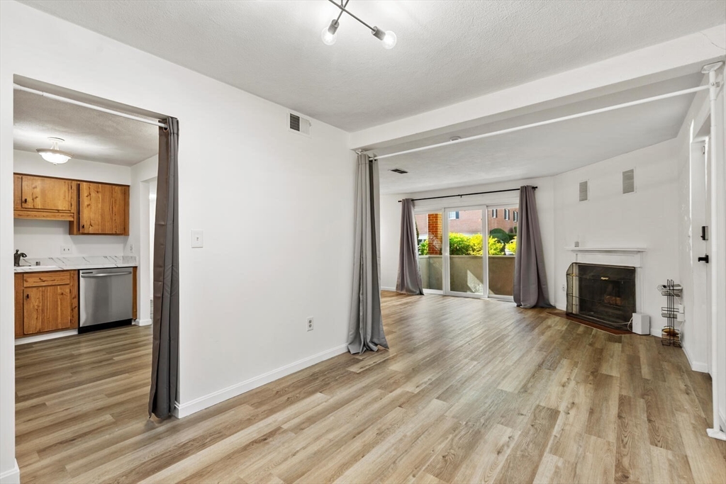 5 April, Unit 12 Lexington, MA 02421 - Photo 14 of 32 a view of an empty room with a fireplace and a window