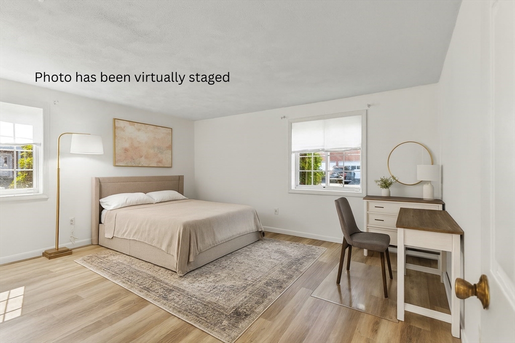 5 April, Unit 12 Lexington, MA 02421 - Photo 22 of 32 a bedroom with a bed and a table