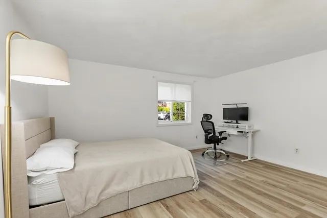 a bedroom with a bed and a chair