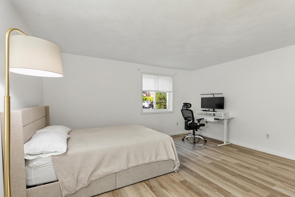 5 April, Unit 12 Lexington, MA 02421 - Photo 25 of 32 a bedroom with a bed and a chair