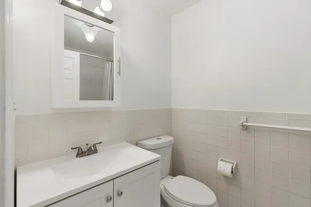a bathroom with a sink toilet and mirror