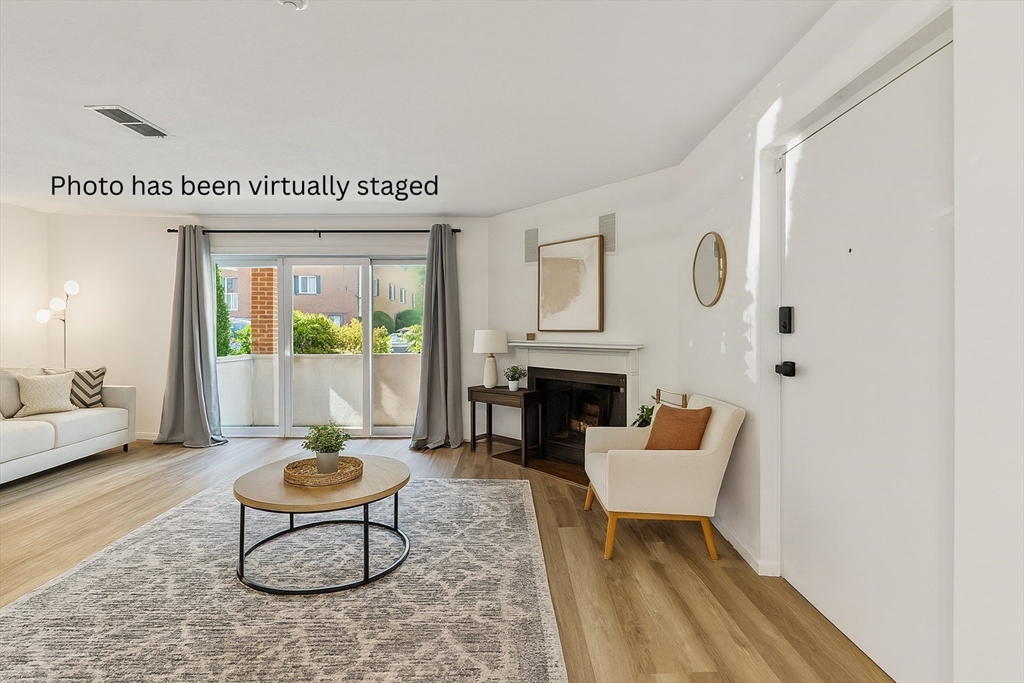 5 April, Unit 12 Lexington, MA 02421 - Photo 3 of 32 a living room with furniture and a fireplace