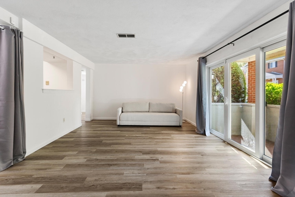 5 April, Unit 12 Lexington, MA 02421 - Photo 4 of 32 a view of a bedroom with wooden floor and bedroom