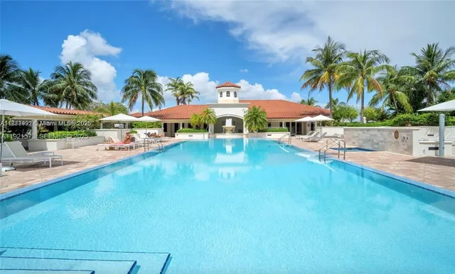 an outdoor space with pool and furniture