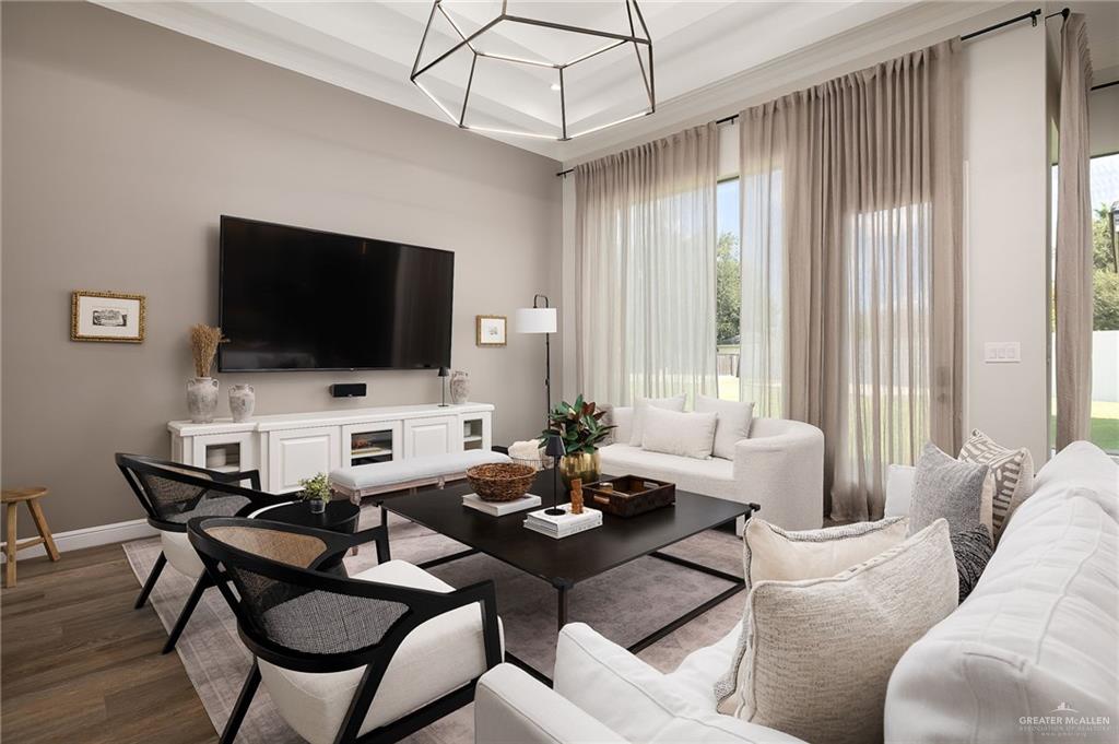 1803 Melissa Rae Drive Mission, TX 78572 - Photo 11 of 31 Living room featuring wood finished floors, a chandelier, and a tray ceiling