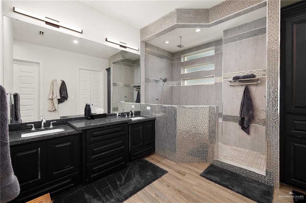 1803 Melissa Rae Drive Mission, TX 78572 - Photo 13 of 31 Full bathroom featuring double vanity, walk in shower, light wood-style floors, and recessed lighting