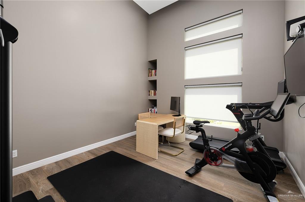 1803 Melissa Rae Drive Mission, TX 78572 - Photo 16 of 31 Workout room featuring light wood-type flooring and a high ceiling