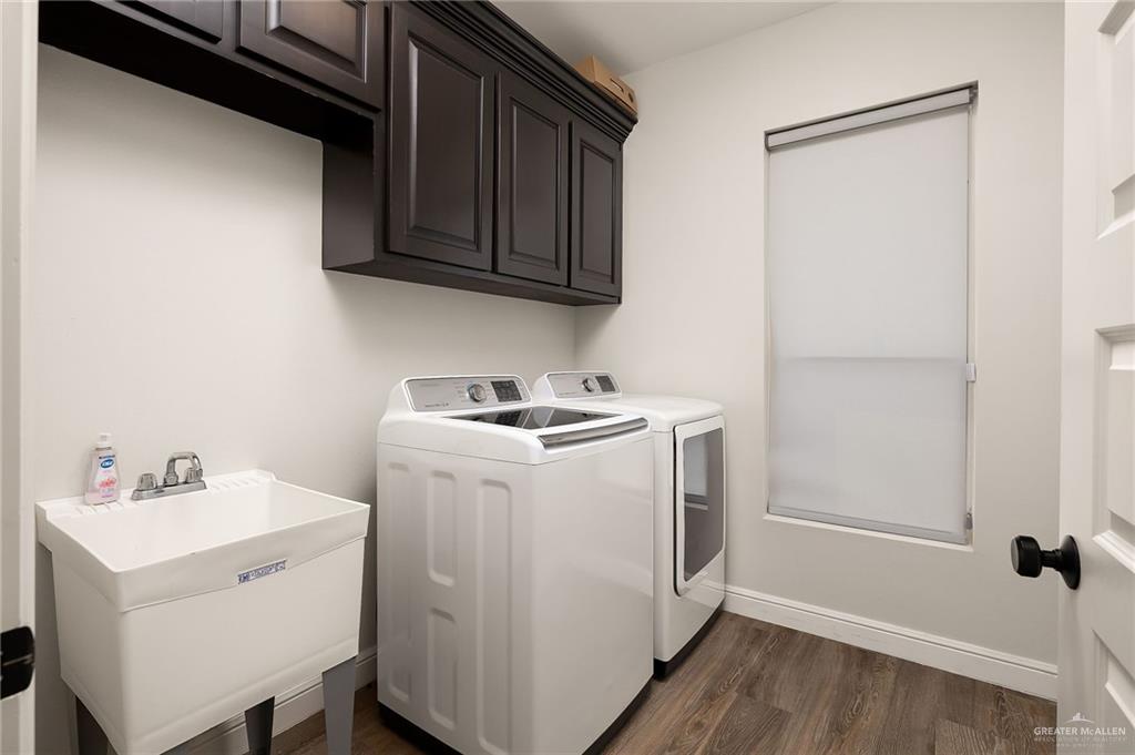 1803 Melissa Rae Drive Mission, TX 78572 - Photo 23 of 31 Washroom with dark wood-style flooring, cabinet space, and independent washer and dryer