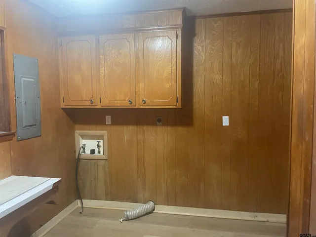 a view of a forest with trees in the background