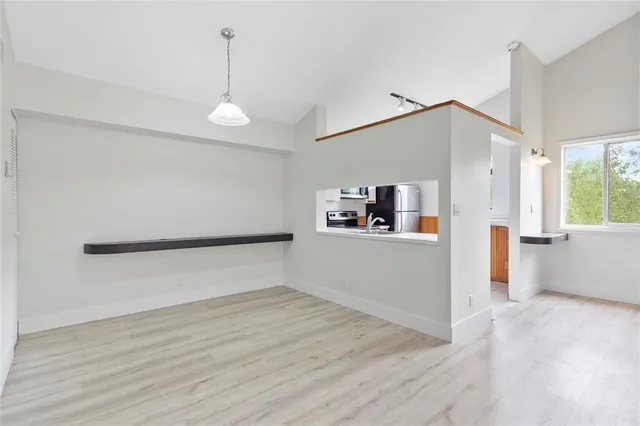 a view of empty room with wooden floor