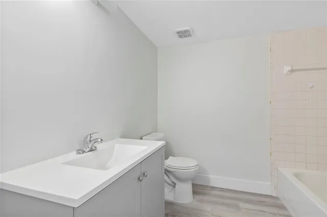 a white toilet sitting next to a white sink