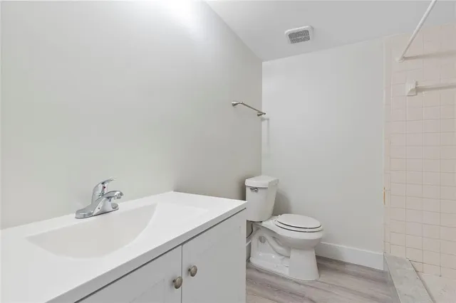 a white toilet sitting next to a bathroom sink