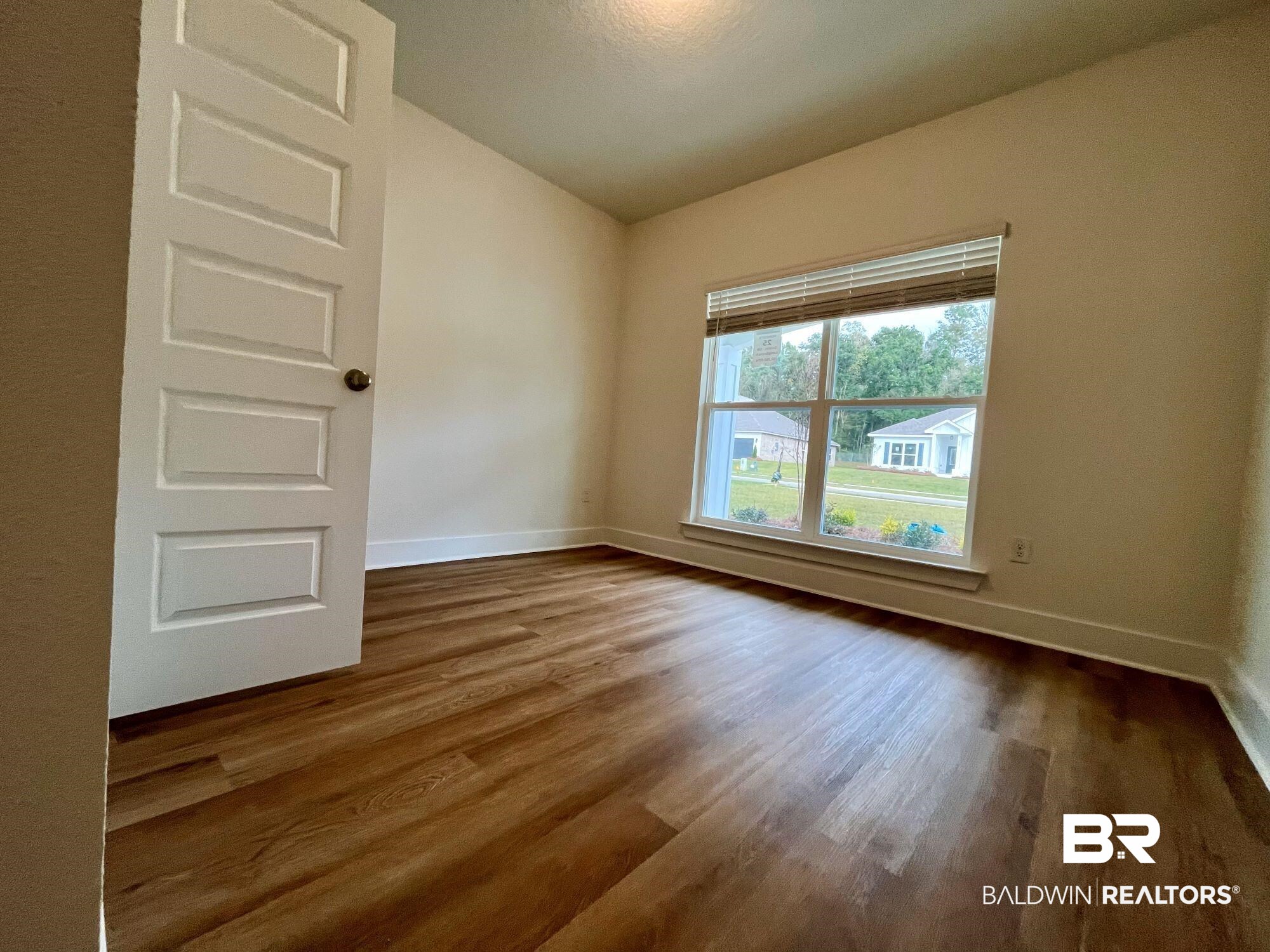 337 Barndling Street Fairhope, AL 36532 - Photo 9 of 34 Unfurnished room with hardwood / wood-style floors