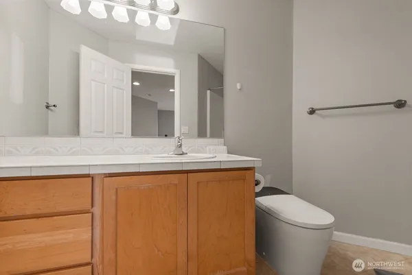 a bathroom with a sink a toilet and mirror