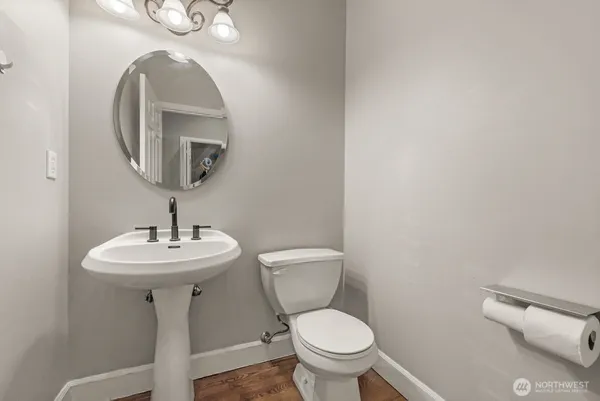 a bathroom with a toilet a sink and mirror