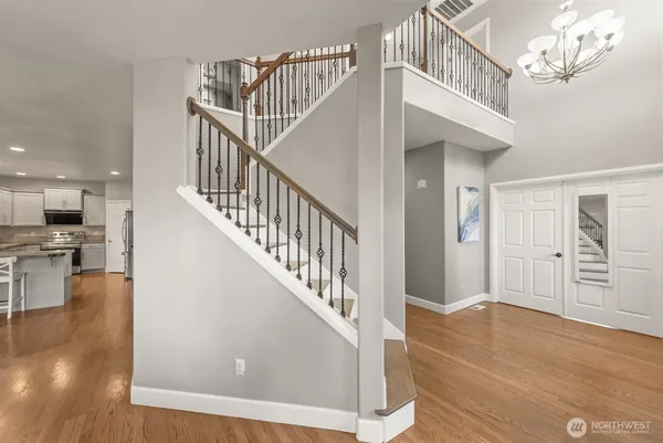 a view of entryway and hall with wooden floor