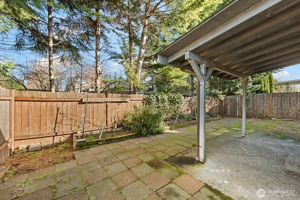 a view of backyard with wooden fence