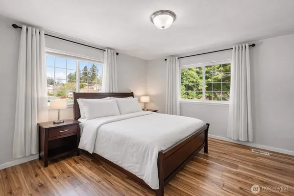 a bed room with a bed and a large window