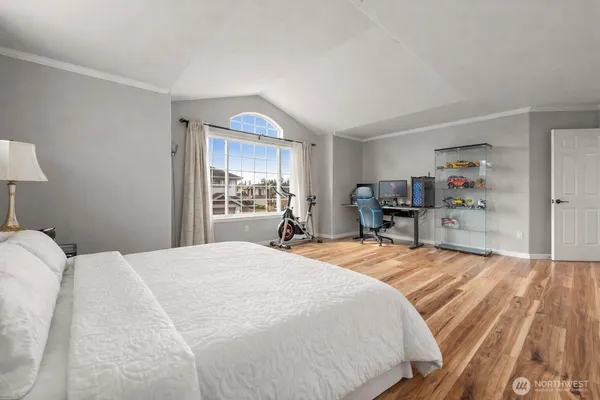 a spacious bedroom with a bed and a dresser in it