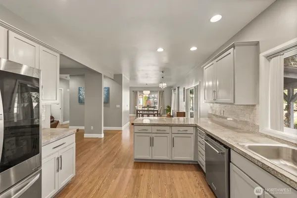 a kitchen with a sink stove cabinets and refrigerator